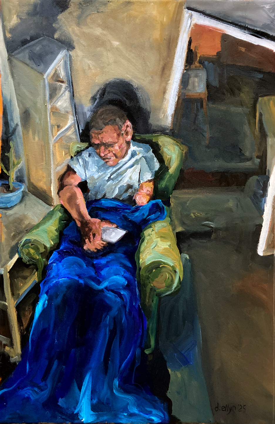 Dana Ellyn’s “Broken” (2025), a figurative oil painting from a loft bed vantage showing Matt Sesow convalescing in a chair under a blue blanket.